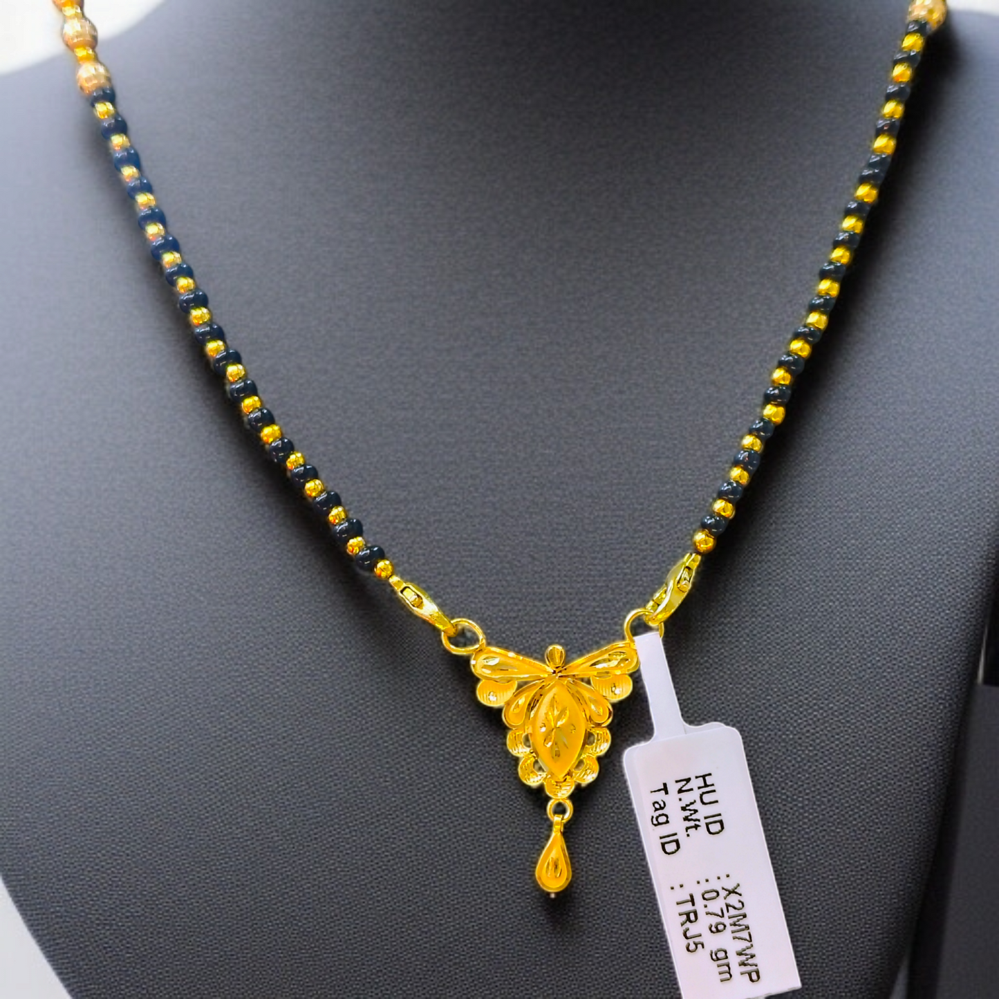 TRJ WGT: 0.790 GM APPROX 22KT HUID HALLMARK GOLD PENDANT MANGALSUTRA 1 PIECE WITH TASSEL.