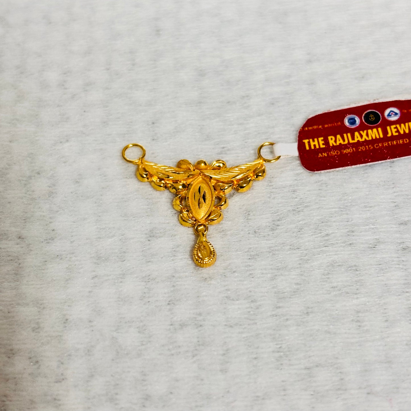 (RP) APPROX WGT: 0.780 GM HUID HALLMARK 22KT GOLD PENDANT (1 PIECE) WITH FREE TASSLE MANGALSUTRA BY RAJLAXMI.