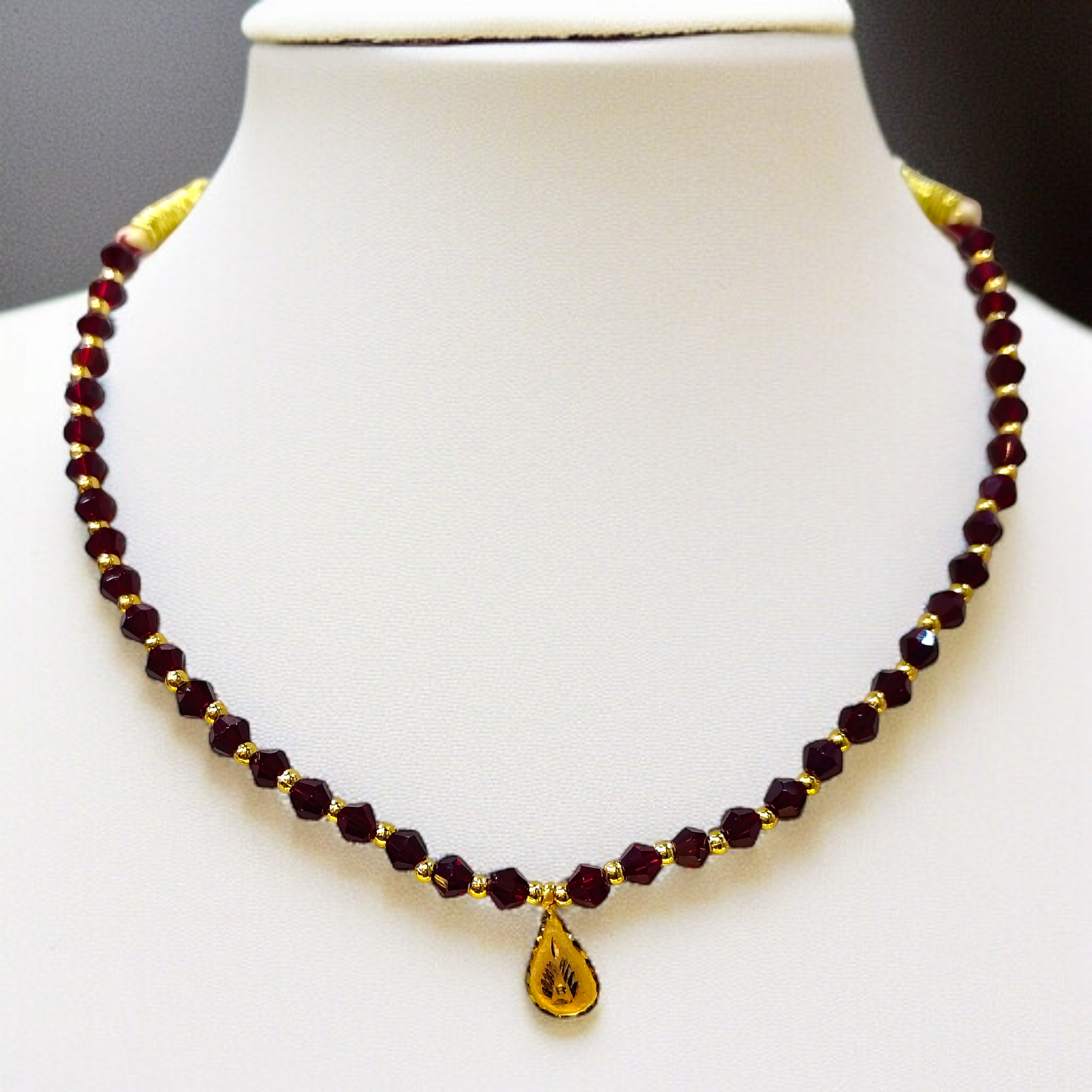 TRJ WGT: 0.140 GM APPROX KDM GOLD DROP DESIGN LOCKET 1 PIECE WITH MAROON CRYSTAL ADJUSTABLE TASSEL FOR GIFT PURPOSE (50 TONCH).