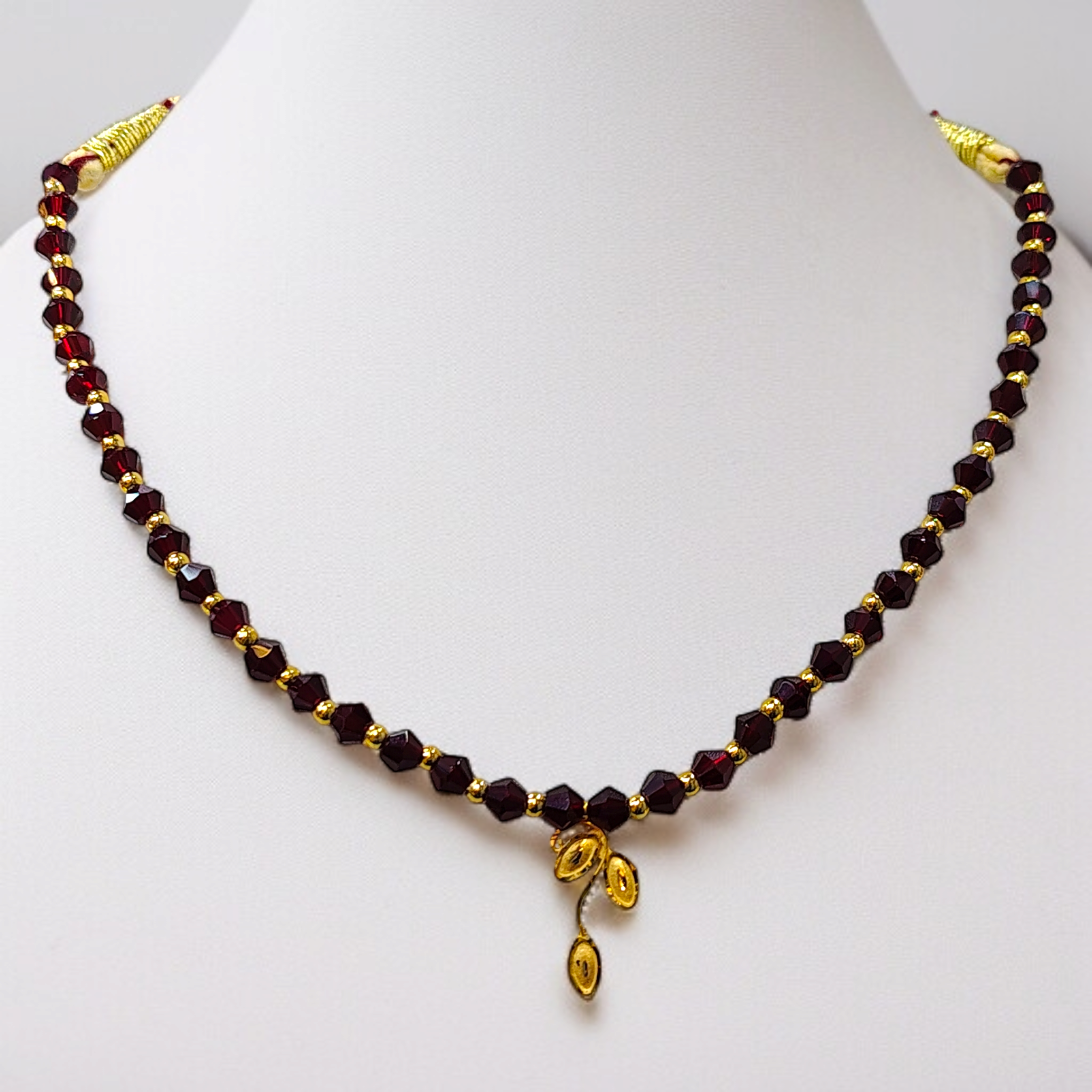 (GML) TRJ WGT: 0.160 GM APPROX KDM GOLD LEAF DESIGN LOCKET 1 PIECE WITH MAROON CRYSTAL ADJUSTABLE TASSEL FOR GIFT PURPOSE (50 TONCH).