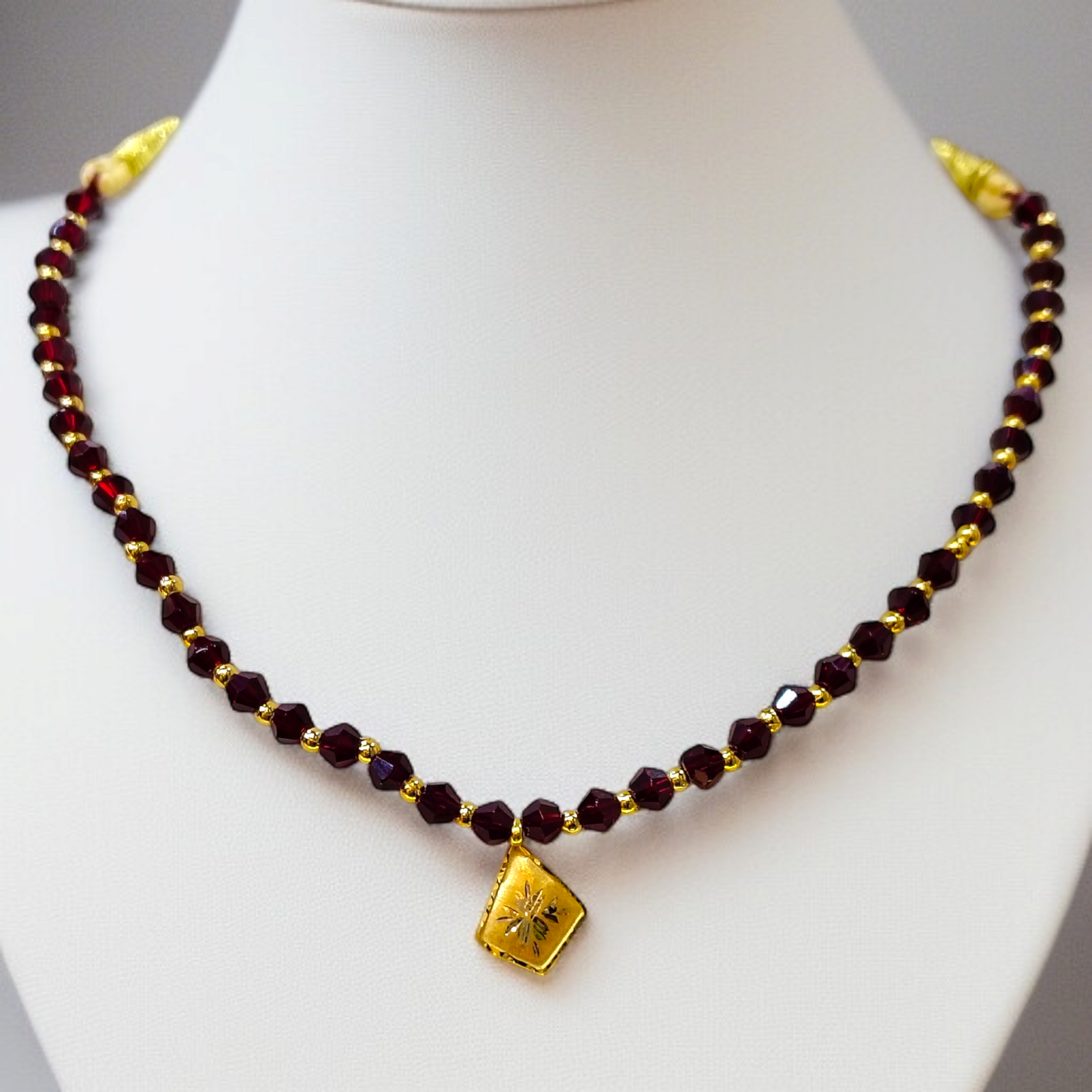 TRJ WGT: 0.150 GM APPROX KDM GOLD BORFI DESIGN LOCKET 1 PIECE WITH MAROON CRYSTAL ADJUSTABLE TASSEL FOR GIFT PURPOSE (50 TONCH).