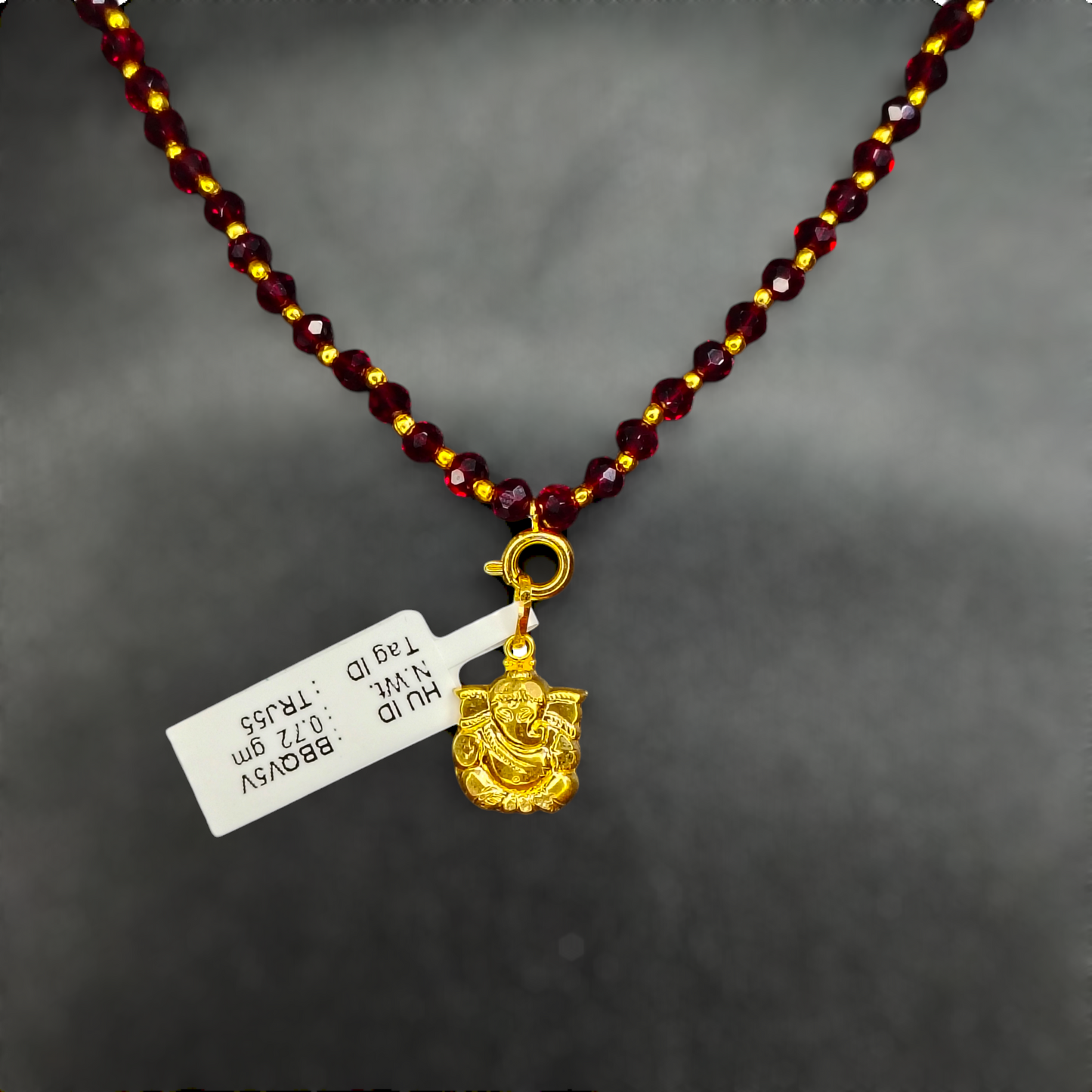 TRJ WGT: 0.720 GM APPROX 22KT HUID HALLMARK GOLD LOCKET 1 PIECE WITH ADJUSTABLE TASSEL.
