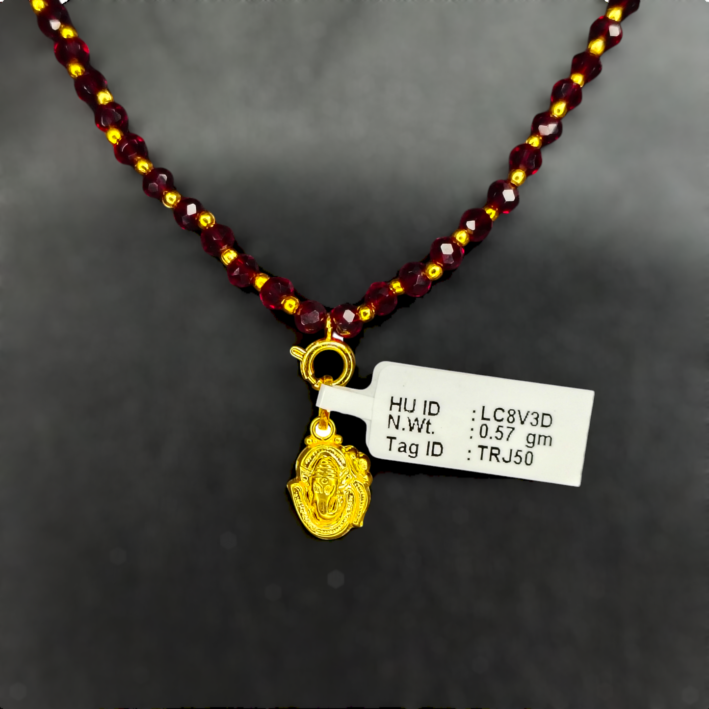 TRJ WGT: 0.570 GM APPROX 22KT HUID HALLMARK GOLD LOCKET 1 PIECE WITH ADJUSTABLE TASSEL.